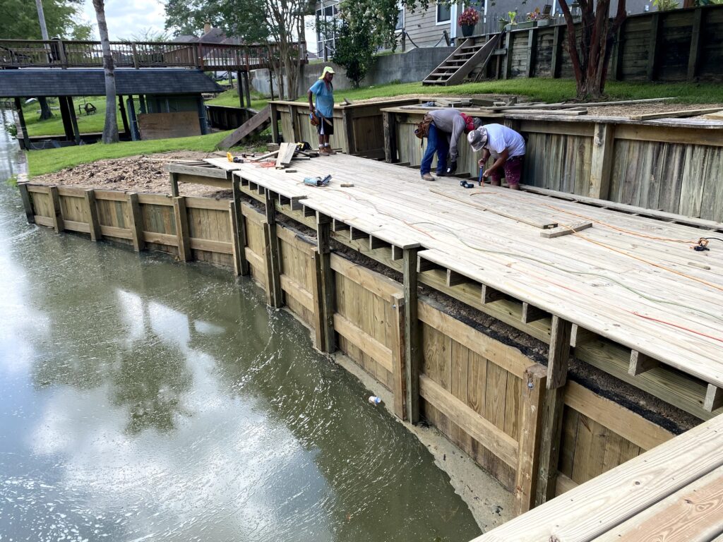 Heavy duty vinyl bulkhead panels supporting waterfront shoreline