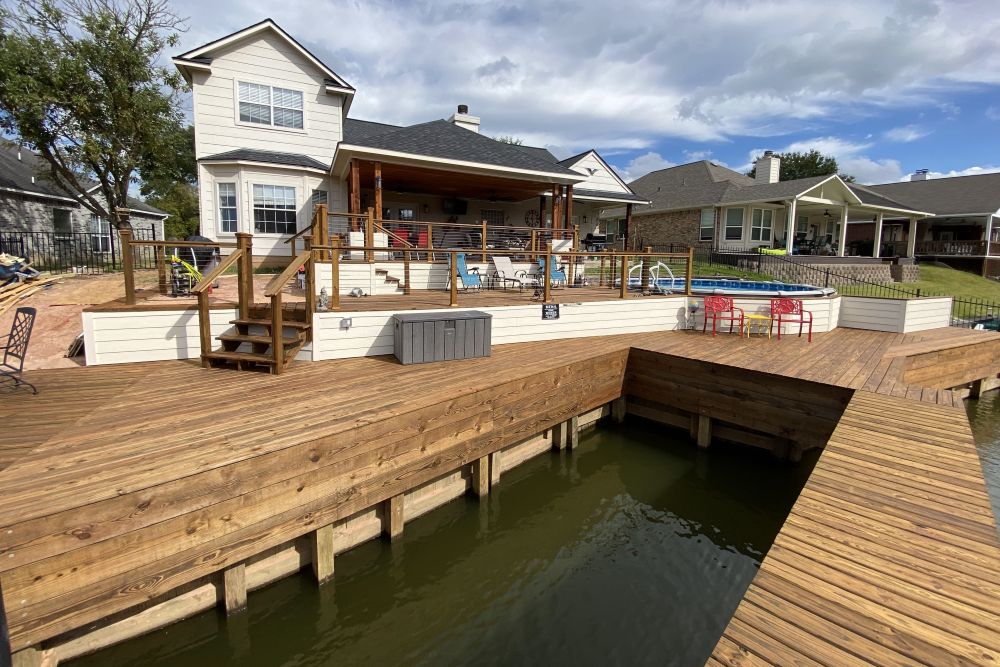 Houston waterfront dock and boathouse during a calm spring morning showing clean decking and maintained structure
